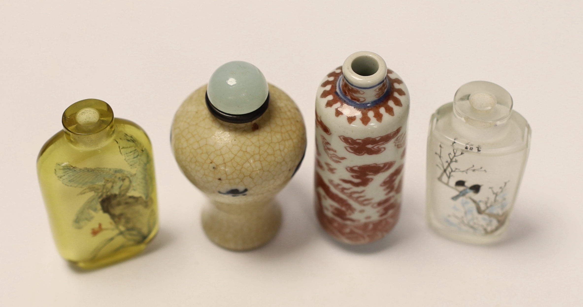 A Chinese crackle glaze snuff bottle, two inside painted glass snuff bottles and an underglaze copper red snuff bottle (4)